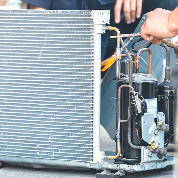 HVAC technicians performing coil service and system maintenance in Maryland