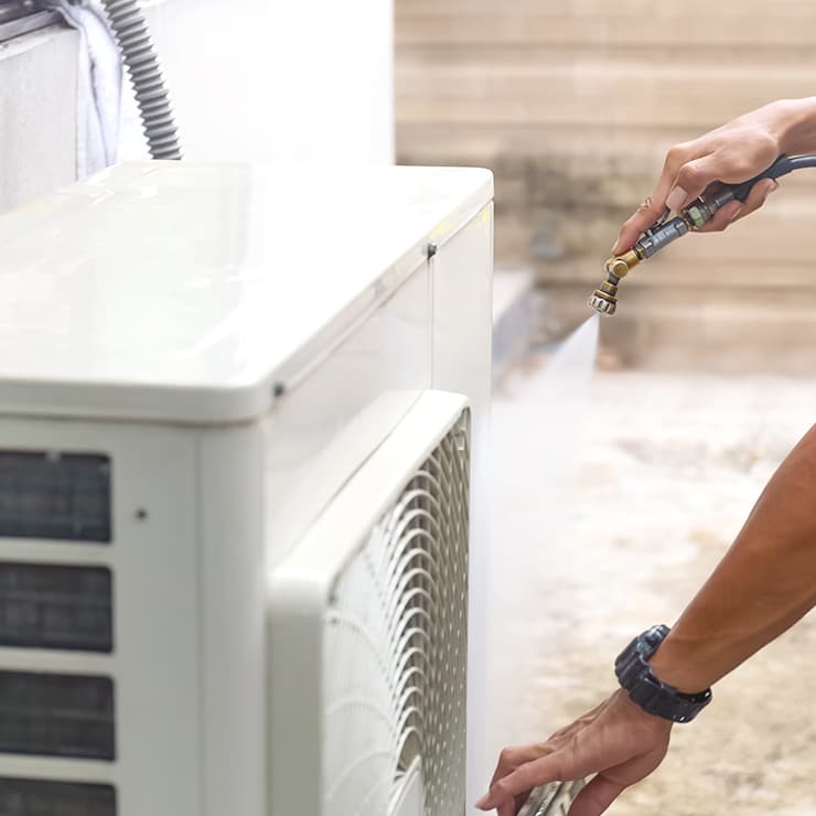 Professional HVAC coil cleaning service for an outdoor air conditioning unit in Maryland