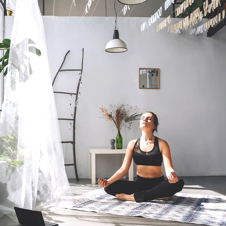 Woman relaxing at home with balanced indoor air after whole-home humidifier installation in Maryland