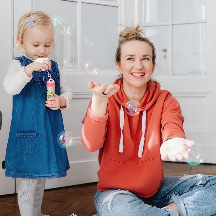 Mother and young daughter enjoying a comfortable, cool home